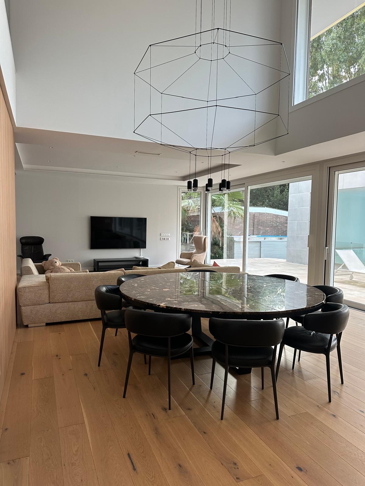 Open-plan living and dining looking out to the pool and gardens